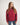 Person wearing a red jumper with a white background