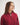 Person wearing a red jumper with a white background