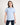 Girl wearing a light blue polo shirt on a white background