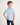 Young boy wearing a light blue polo shirt against a plain background