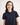 Girl wearing a navy blue polo shirt on a white background