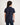 Girl wearing a navy blue polo shirt on a white background