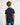 Boy wearing a navy blue polo shirt on a white background
