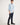 Boy wearing a light blue workshirt with rolled-up sleeves on a white background