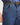 Close-up of blue jeans with a black belt and gold buckle.