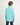 Young boy wearing an aqua shirt and jeans on a white background