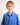 Young boy wearing a blue workshirt against a plain background