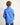 Young boy wearing a blue workshirt against a plain background