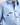 Young boy wearing a light blue workshirt with a white background
