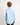 Young boy wearing a light blue workshirt with a white background