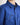 Close up of young boy wearing a dark blue workshirt with a white background