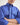 Boy wearing a blue workshirt with a plain background