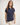 Girl wearing a navy polo shirt on a white background