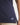 Girl wearing a navy polo shirt on a white background