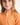 Young girl wearing an orange polo shirt with a logo on a plain background