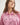 Girl wearing a pink workshirt with a visible RB logo on a white background