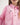 Close-up of a pink workshirt with buttons and a logo on a plain background