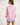 Girl wearing a pink workshirt with a visible RB logo on a white background