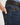 Close-up of blue jeans with a brand logo on a white background