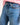 Close-up of blue jeans with pink stitching on a white background