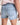 Denim shorts with a brand logo on a plain background