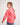 Young girl wearing a pink workshirt and blue shorts on a white background
