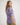 Girl wearing a purple workshirt and green shorts on a white background