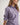 Girl wearing a purple workshirt and green shorts on a white background