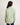 Young girl wearing a light green shirt with a white background
