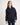 Person wearing a navy blue jumper with a white background