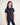 Girl wearing a navy blue polo shirt on a white background