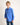 Young boy wearing a blue workshirt against a plain background