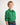 Boy wearing a green workshirt with a plain background