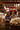 Two women working with wool in a barn setting