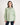 Young girl wearing a light green shirt with a white background