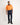 Man wearing an orange and navy hi-vis Australian cotton work shirt on a plain background - full body view