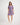 Girl wearing a colorful floral dress on a white background