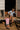 Two children interacting with chickens in a barn setting