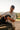 Man holding a dog in a 4x4 vehicle with a scenic background